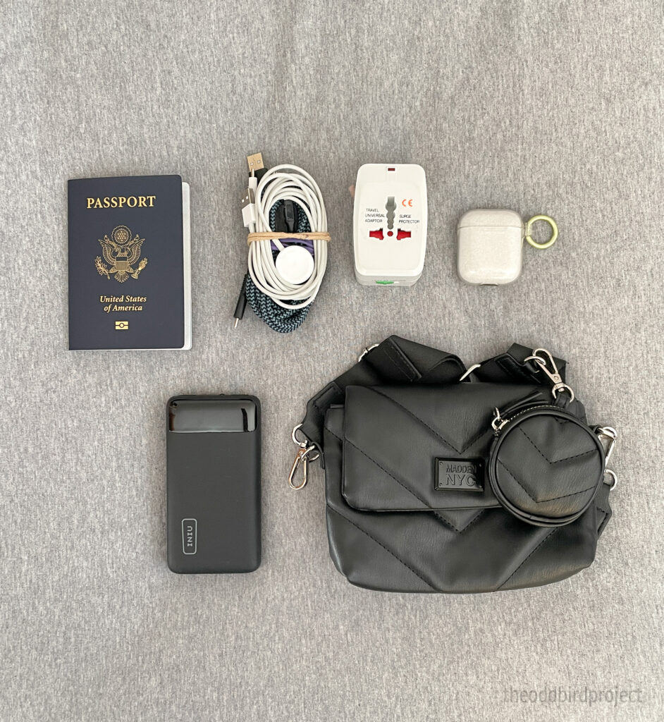 image of electronics and travel documents for packing light for travel